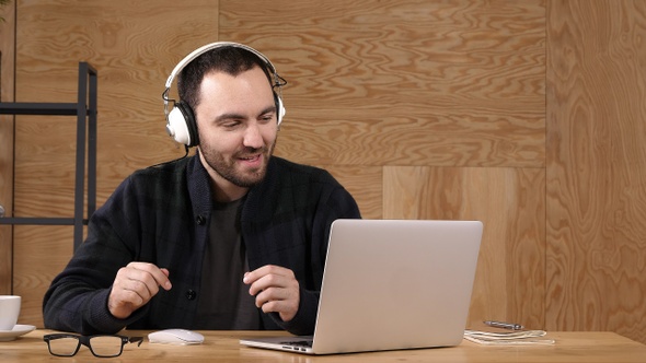 Casual man in headphones listening music.