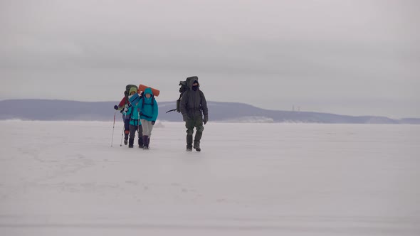 Group of People Walking in Snow