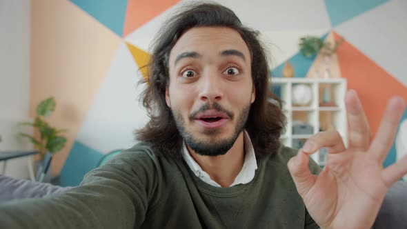 Slow Motion Portrait of Handsome Arab Man Looking at Camera Talking and Showing OK Hand Gesture