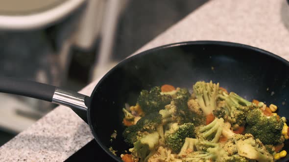 Vegetables Are Fried In A Wok Pan