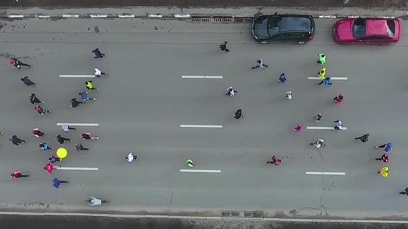 Top Down Aerial of People Running at Sports Race Marathon on City Road