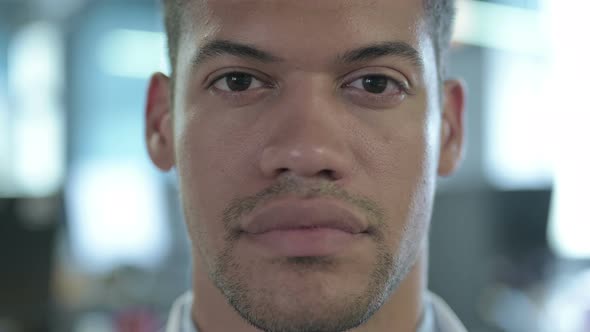 Close Up of Serious African Man Looking at Camera