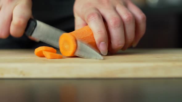 Woman Cutting the Carrot