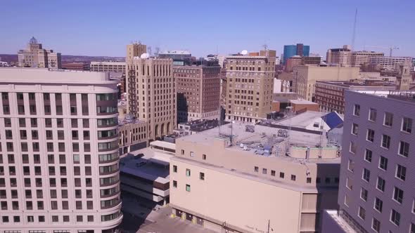 Rising aerial pan of skyline of Grand Rapids, Michigan, on sunny day