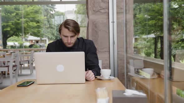 Concerned Businessman Working on Laptop