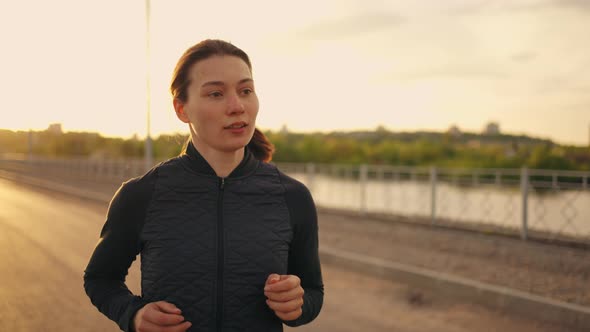 Portrait of Running Woman Female Athlete is Jogging in Morning Pretty Lady is Training Outdoors