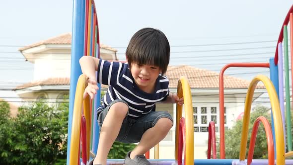 Asian Child Playing On Playground In Summer Outdoor Park Slow Motion