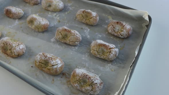 Freshly baked chewy pistachio amaretti Christmas cookies on a baking sheet