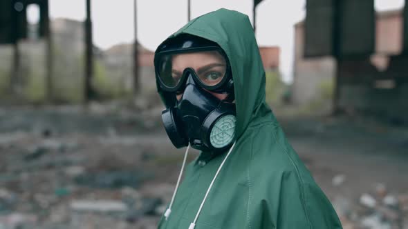 Human in gas mask near abandoned building