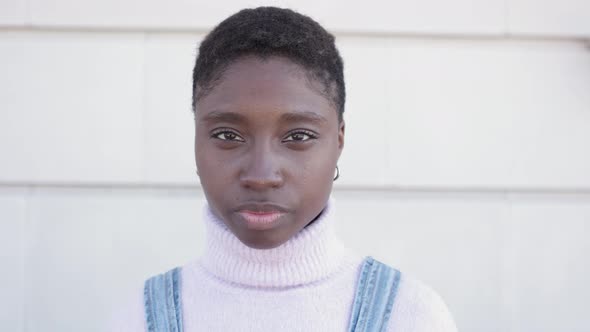 Portrait of Confident Young Adult African Woman Looking at Camera Outdoors