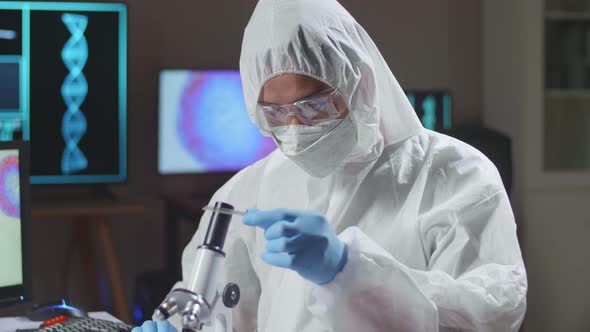 Asian Doctor In Protective Suit Working And Developing Vaccine In A Modern Lab