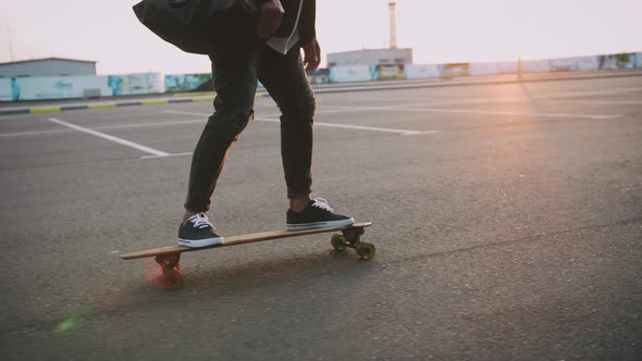 Close Up Shot of Man Riding on Longboard During Sunset Slow Motion