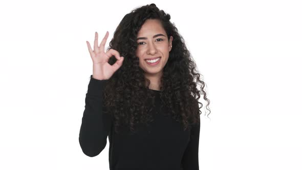 Portrait of Charming Curly Long Haired Adult Girl Happily Showing Thumb Up Isolated on White