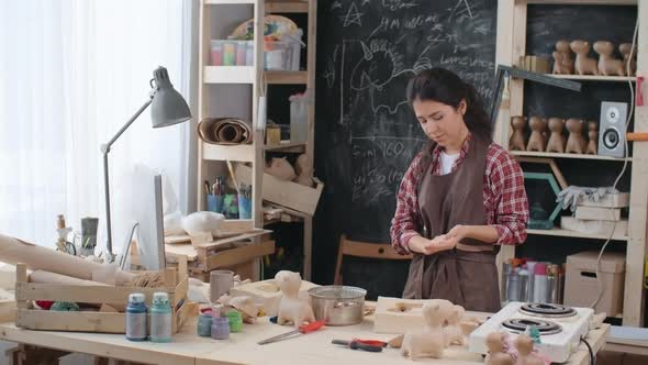 Woman Gluing Craft Paper to Mold