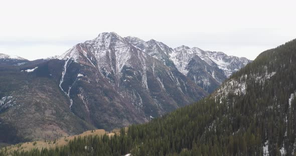 Rocky Mountains in Colorado with pine trees. Drone videoing sideways.