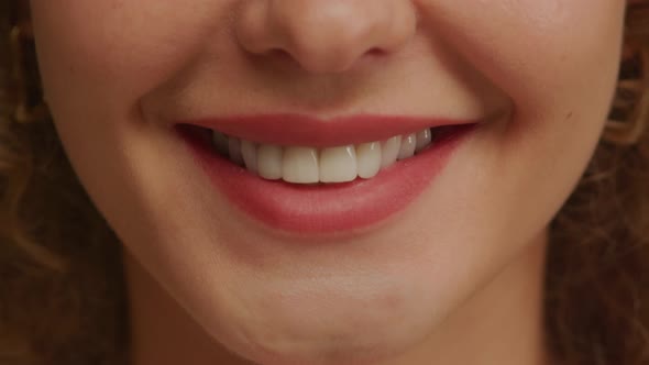 Close Up of a Charming Woman Smile with Perfect Natural Teeth and Bright Lipstick