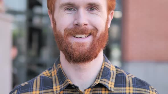 Close Up of Smiling Redhead Beard Young Man Outdoor