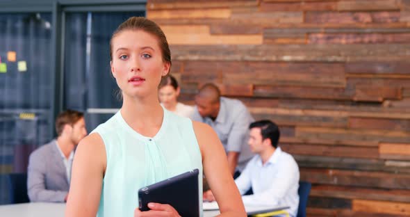 Portrait of business executive holding digital tablet