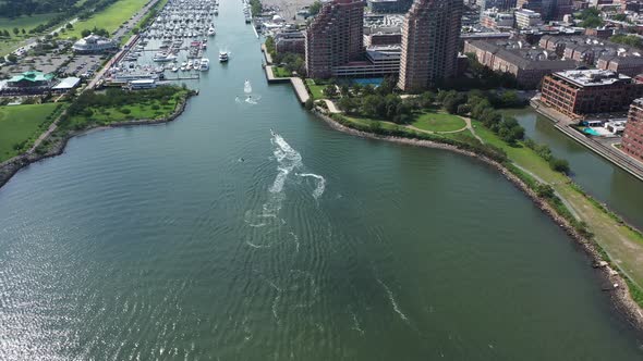 A high angle drone shot looking down on several watercraft riders in the Hudson River. The drone cam