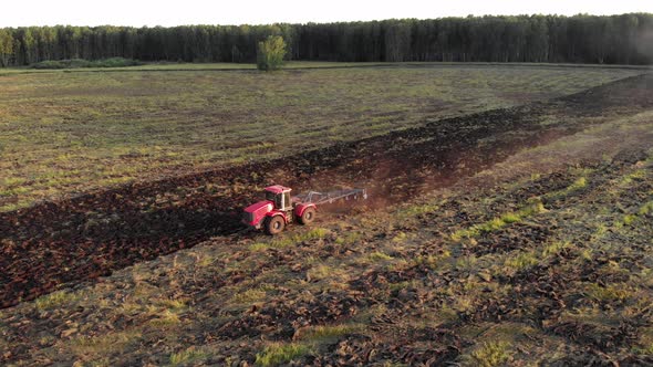 Tractor Plowing Grassy Field