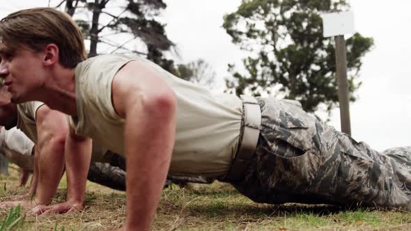 Military soldiers dosing push-ups during obstacle course 4k