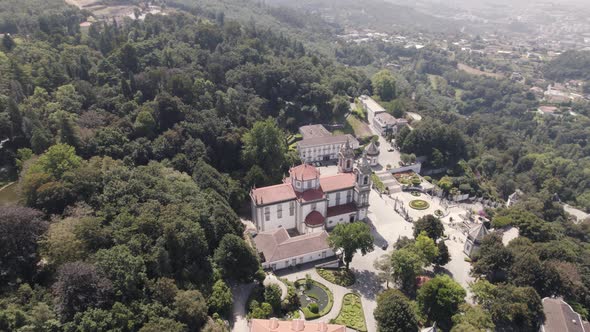 Aerial top down view Sanctuary of Bom Jesus Surrounded By nature, hill mountain - Braga