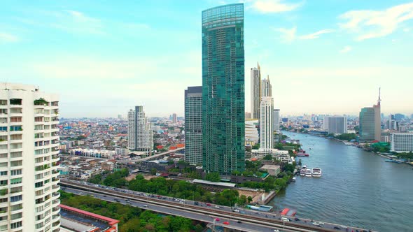 4K : Drones fly over the Chao Phraya River, buildings and business districts in Bangkok