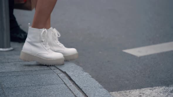 Female Legs Walking Crossroad in Urban Background City Landscape