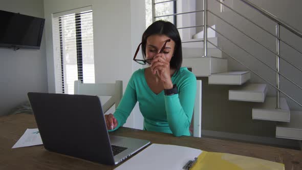 Portrait of african american woman using laptop while working from home