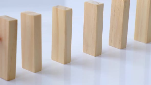 Domino Effect Row of Wooden Domino Falling Down on White Background