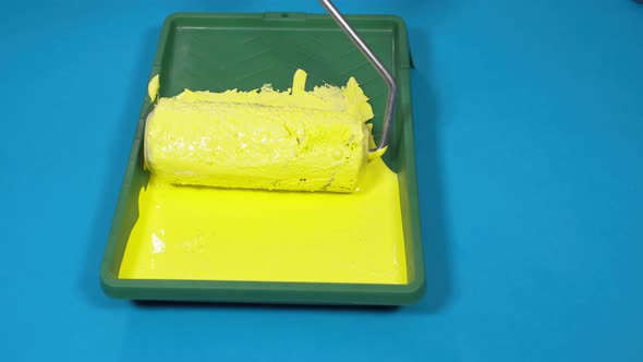 Close Up of Plastic Tray with Yellow Paint on Blue Background