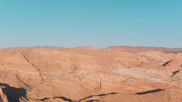 Wide and slow moving aerial over Utah's Snow Canyon.