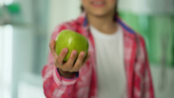 Happy Child Holding Green Apple, Natural Food for Immunity, Healthcare Concept