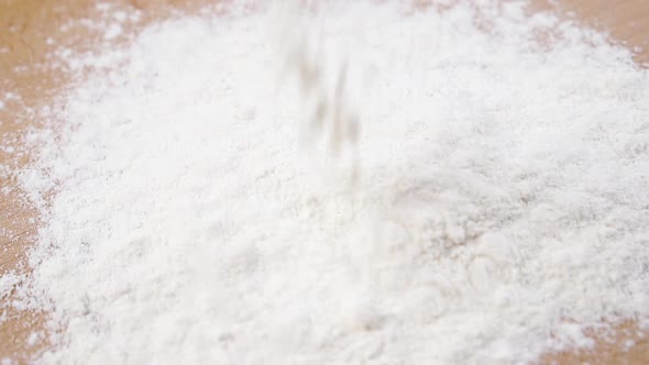 White wheat flour is poured into a heap 