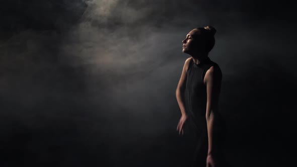 Graceful Female Artist Making Dance Moves in Dark