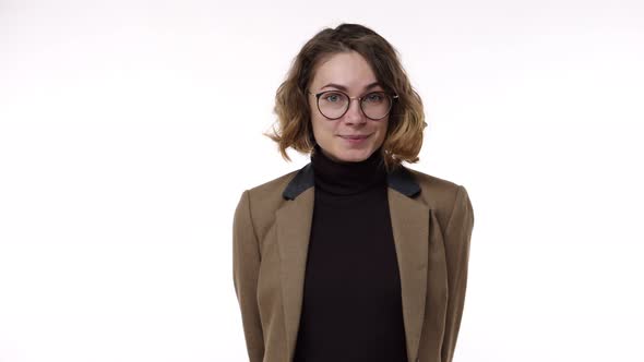 Portrait Closeup of Adorable European Woman Wearing Brown Jaket and Stylish Glasses Curly Short