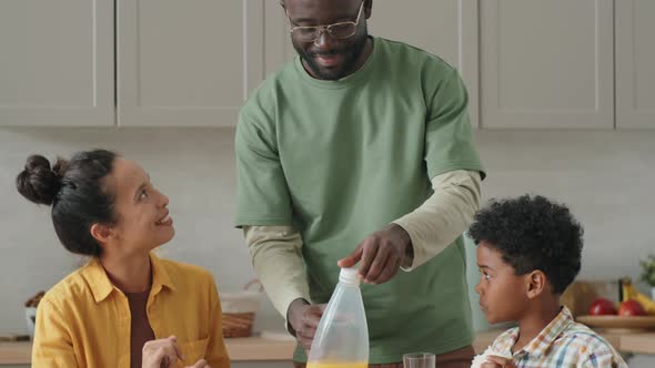 African Family Talking and Eating Breakfast at Home