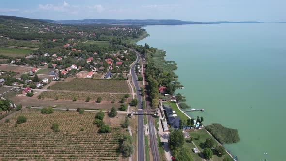 Aerial view of Lake Balaton, road, houses, fields and gardens in Hungary