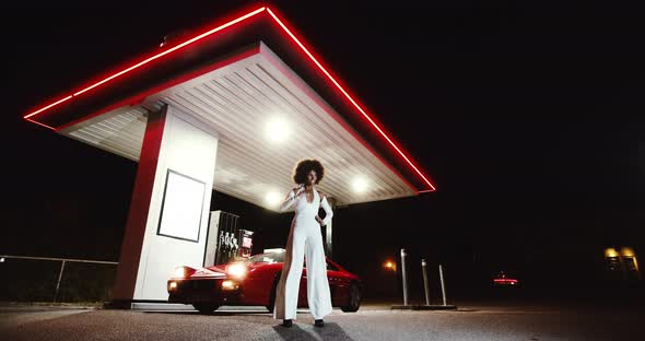 Posing Woman In Jumpsuit In Front Of Red Ferrari 348 TB