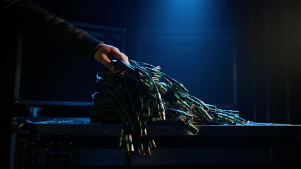 A Man Takes a Bunch of Wires to Connect Concert Sound