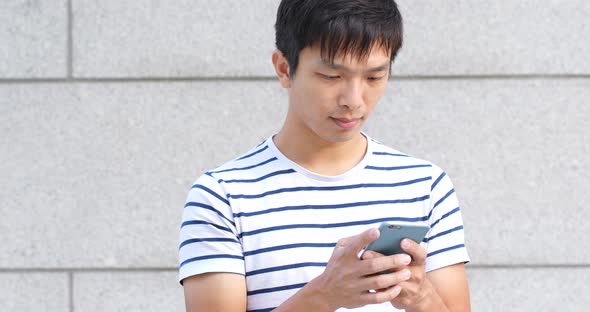 Asian young man use of mobile phone