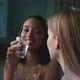 Two girls having drinks and talking on the balcony - VideoHive Item for Sale