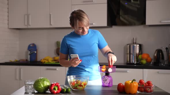 Slimming Woman Weighing Vegetables in Kitchen