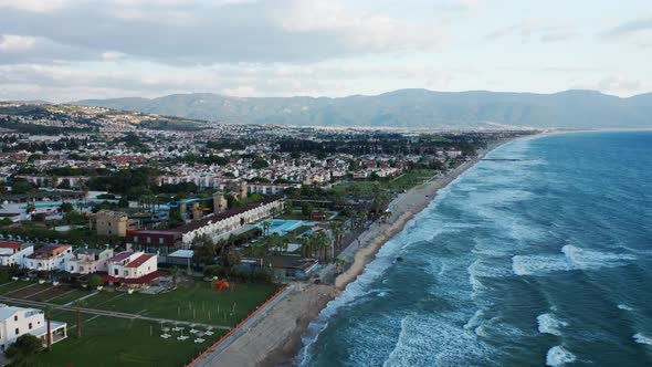 Aerial view of amazing coastal scenery, resort town of Kusadasi, Turkey and long sandy beach, calm s