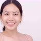 Slow motion of Asian girl with natural make up looking to camera and patting her body gently. - VideoHive Item for Sale