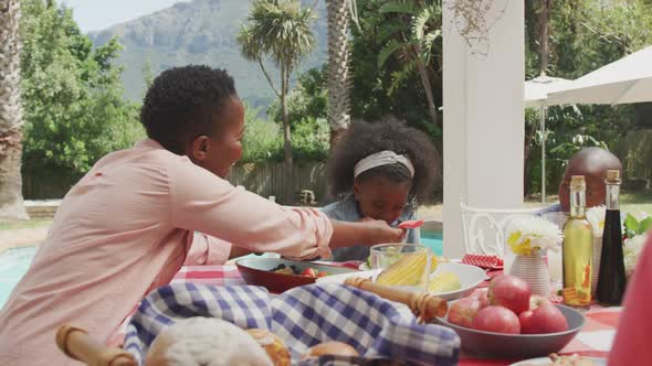 Happy family eating together at table