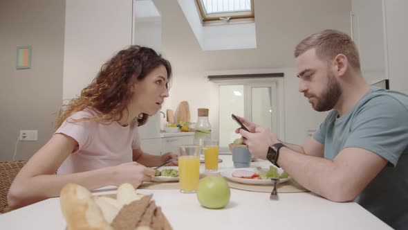 Husband Sending Messages on Smartphone during Meal and Wife Grabbing It