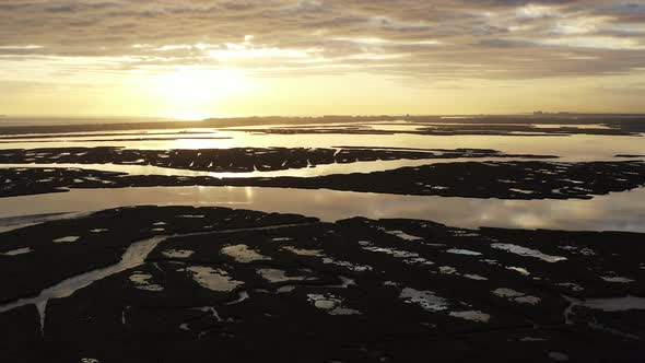 An aerial shot over Baldwin Bay near Freeport, NY at sunset. The camera truck left & pan right while