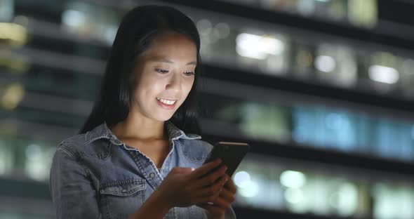 Businesswoman use cellphone at night