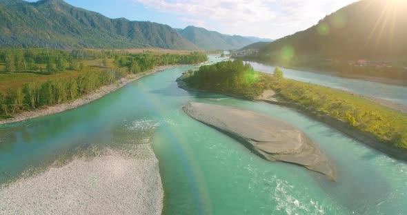 Low Altitude Flight Over Fresh Fast Mountain River with Rocks at Sunny Summer Morning